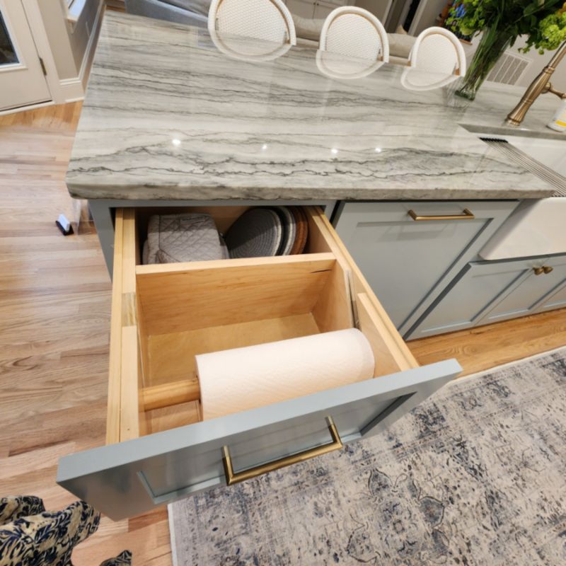 Modern kitchen with wooden cabinets and marble countertop storage in Raleigh, NC