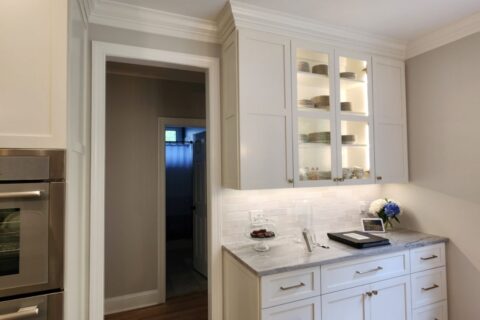 Organized pantry with labeled containers on wooden shelves in Raleigh, NC